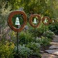 Four Mirthwick cairn garden stakes in a planted garden border